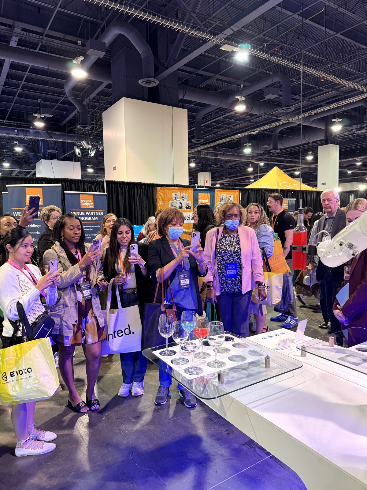 Crowd of wedding planners filming the RoboBar robotic bartender at the Wedding MBA trade show